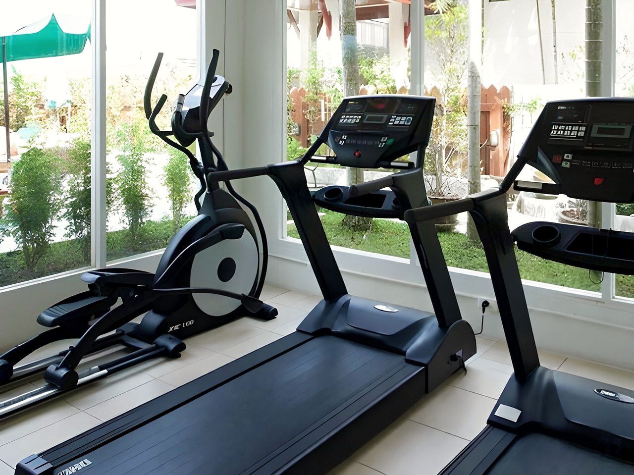 The fitness room, with treadmills by windows onto the garden